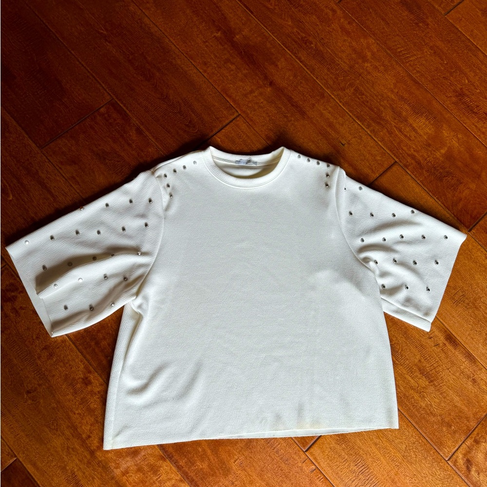 Cool white shirt with studs.